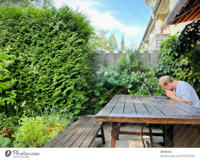 Frustration in garden office | man sits at table in front of laptop and holds hands in front of face Garden Terrace Work and employment Workplace Man Table