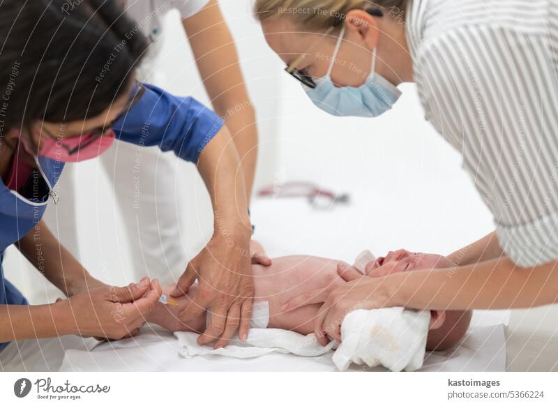 Baby beeing vaccinated by pediatrician in presence of his mother. Preventive vaccination against Diphtheria, whooping cough, tetanus, hepatitis, haemophilus influenzae, pneumococcus, poliomyelitis