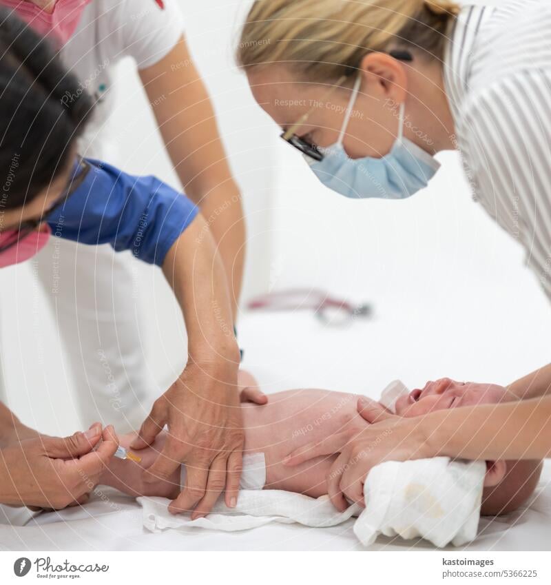 Baby beeing vaccinated by pediatrician in presence of his mother. Preventive vaccination against Diphtheria, whooping cough, tetanus, hepatitis, haemophilus influenzae, pneumococcus, poliomyelitis