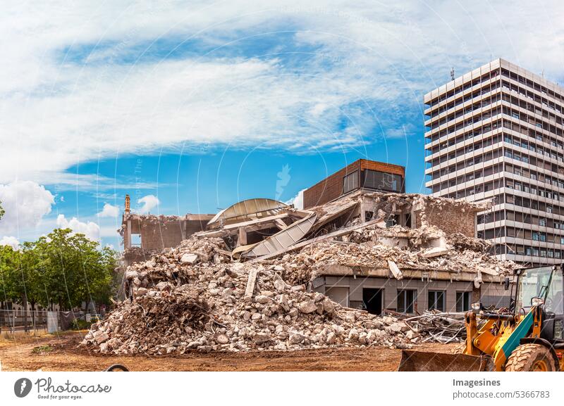 Demolition old building. Excavator destroys old house. Destruction of dilapidated housing for new construction. Freeing space for the construction of a new building.