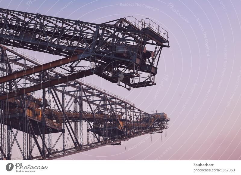 View of boom, struts and structures of a conveyor bridge against evening sky Overburden conveyor bridge romantic Violet Outrigger far Large f60 Industry