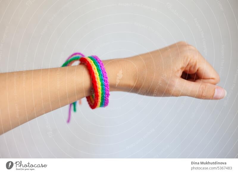 Hand holding rainbow crochet handmade bracelet. Celebrating Pride month with symbol colors of lgbt abstract art backdrop background business colorful concept