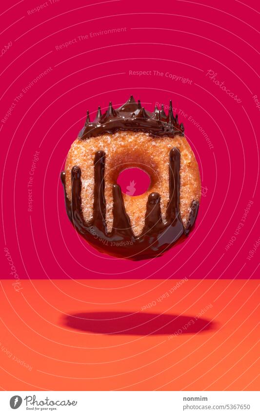 Floating chocolate coated ring doughnut queen concept vibrant pink orange donut crown drop drip melted levitating sweet sugar unhealthy magenta cake circle