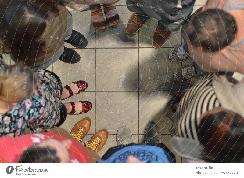 Group of people standing in a circle viewed from above group Circle at the same time together pray talk about Anonymous Bird's-eye view Team in common Teamwork