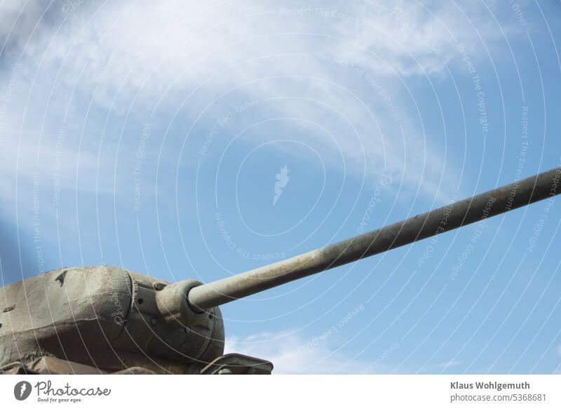 An old T34 main battle tank of the red army stands under a slightly cloudy sky, the cannon pointing forward. Shell Armouring Tank gun Cannon Red Army Sky