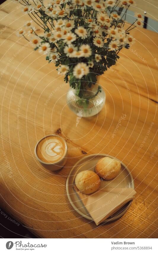 coffee and flowers in the table vase bouquet nature still life decoration spring yellow glass plant blossom color home floral green interior pink rose wood