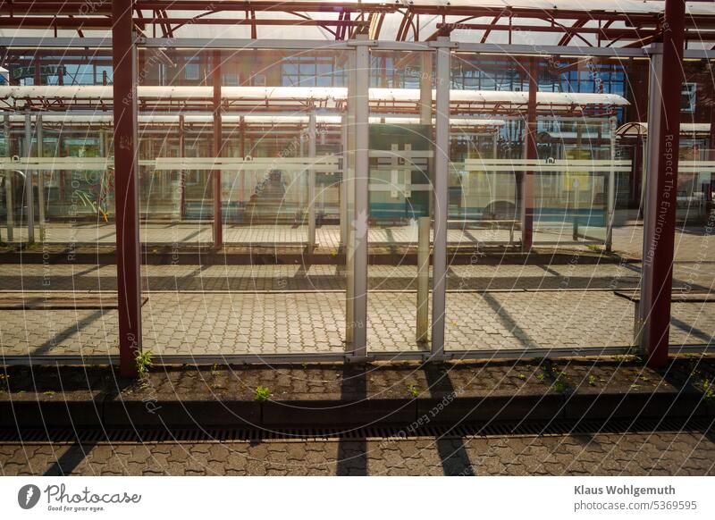 Abandoned platforms of a bus station in the early morning Light Shadow shadow cast Safety glass Bus terminal Platform Interlocking paving stone composite paving