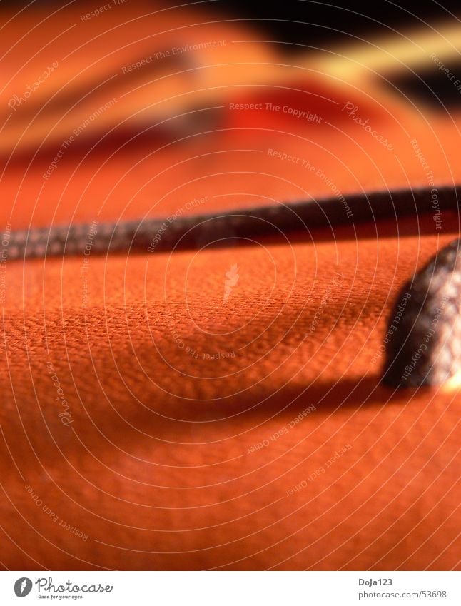 Orange pendant Bag Loop Brown Affectionate Fresh Macro (Extreme close-up) Depth of field Interior shot Colour Sewing thread Plastic rough surface Shadow Warmth