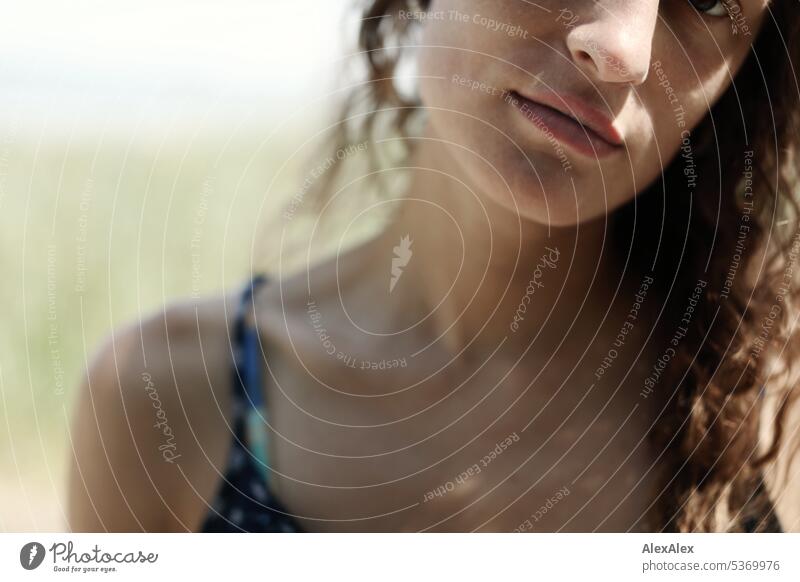 Detail- portrait of young beautiful brunette woman by the sea - dimples, lips, nose and shoulder warm Summery Beautiful weather proximity Day tranquillity