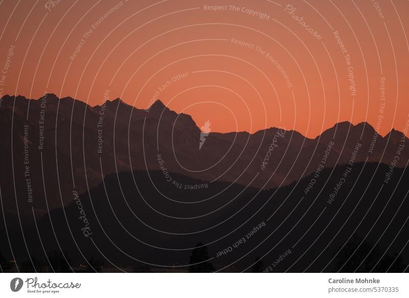 Mountain range in deep sunset red Sky Swiss mountains Alps Switzerland Landscape Peak Exterior shot Nature Deserted Snowcapped peak Beautiful weather