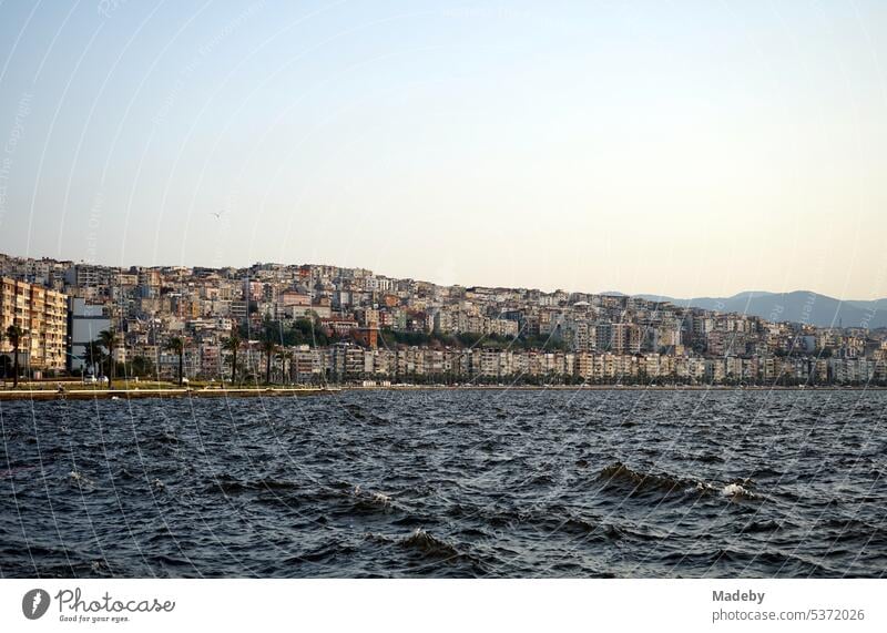 View from the pier in Konak district of Izmir bay and the coast with mountains in summer sunshine on the Aegean Sea in Turkey Transport postcard idyll Swell