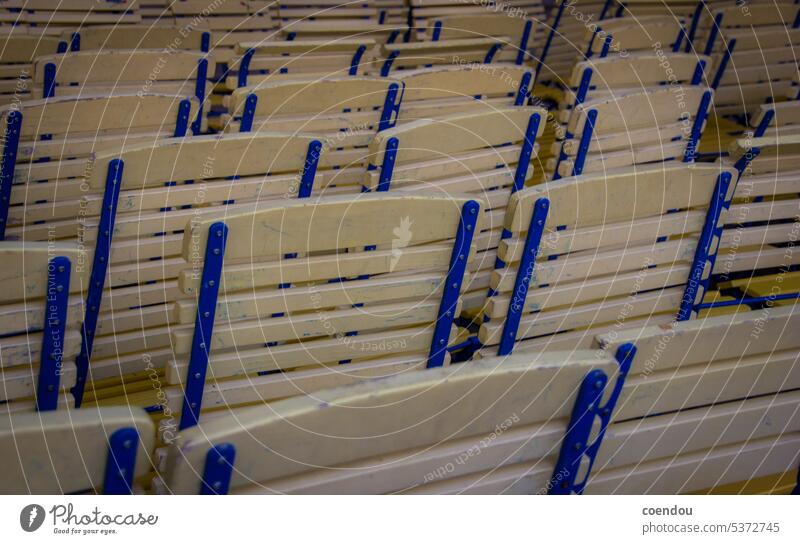 Rows of chairs from yellow and blue wooden chairs Chair rows Row of chairs Yellow Blue Yellow-Blue empty chairs empty rows of chairs Wooden chairs