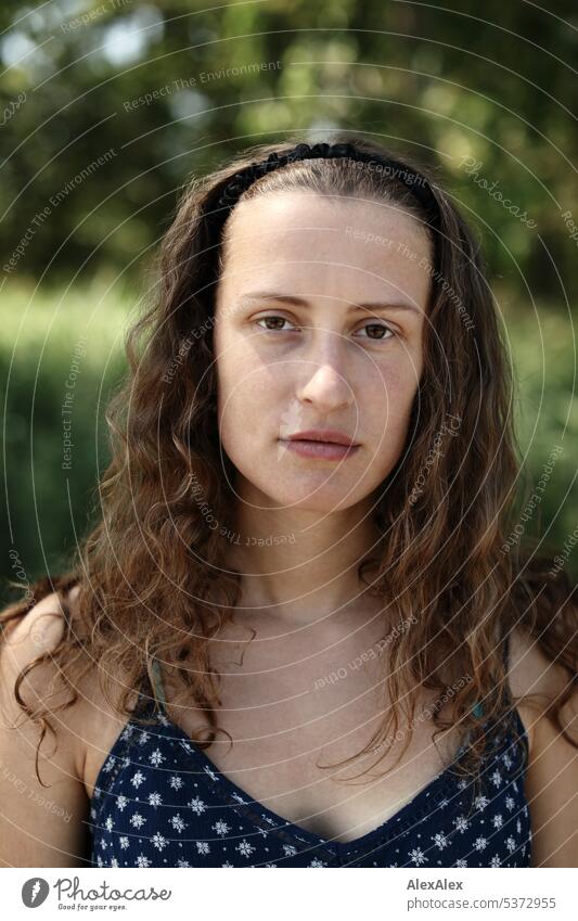 direct portrait of young beautiful brunette woman in front of forest warm Summery Beautiful weather plants proximity Day tranquillity Self-confident