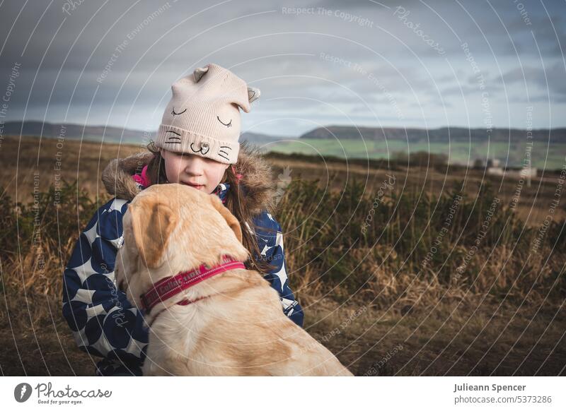 Child with Labrador Retriever in the countryside labrador girl moors Dog Animal Pet Animal portrait Exterior shot retriever Love of animals Cute Happy child