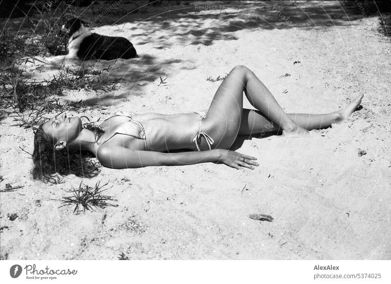 analog black and white side full body portrait of young beautiful woman on beach warm Summery Beautiful weather Day Self-confident Youthfulness Skin