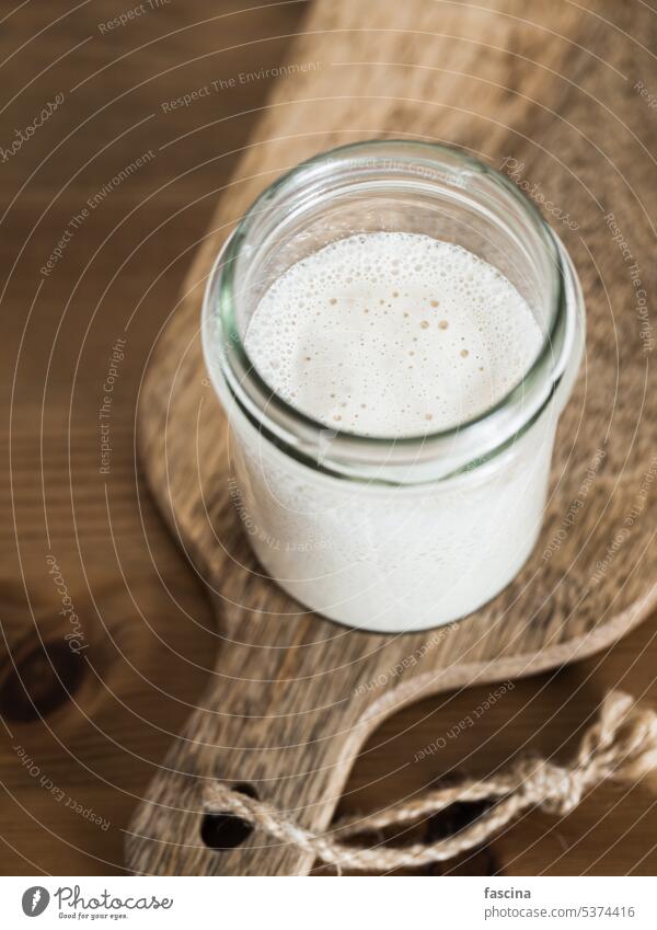 Wheat sourdough starter, copy space, vertical dough ingredient bake baking being baked bread making breadmaking bread-making glass jar nobody no-one pastry