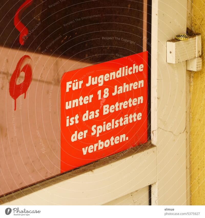 Young people under 18 are forbidden to enter the venue - it says on a dirty glass door Access denied Casino Front door Game of chance Compulsive gambling