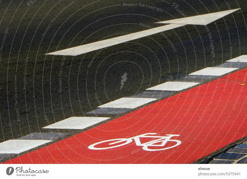 Arrow as road marking next to a red marked bike lane with pictogram / road safety ride a bicycle cycle path Cycle path Road marking Road safety Pictogram Blog