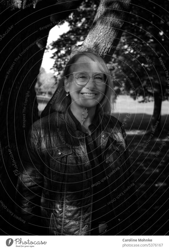 Shadow play woman smiling under trees in light play with sun and shadow Woman Laughter fortunate Joy Happiness Happy Smiling portrait Face Contentment