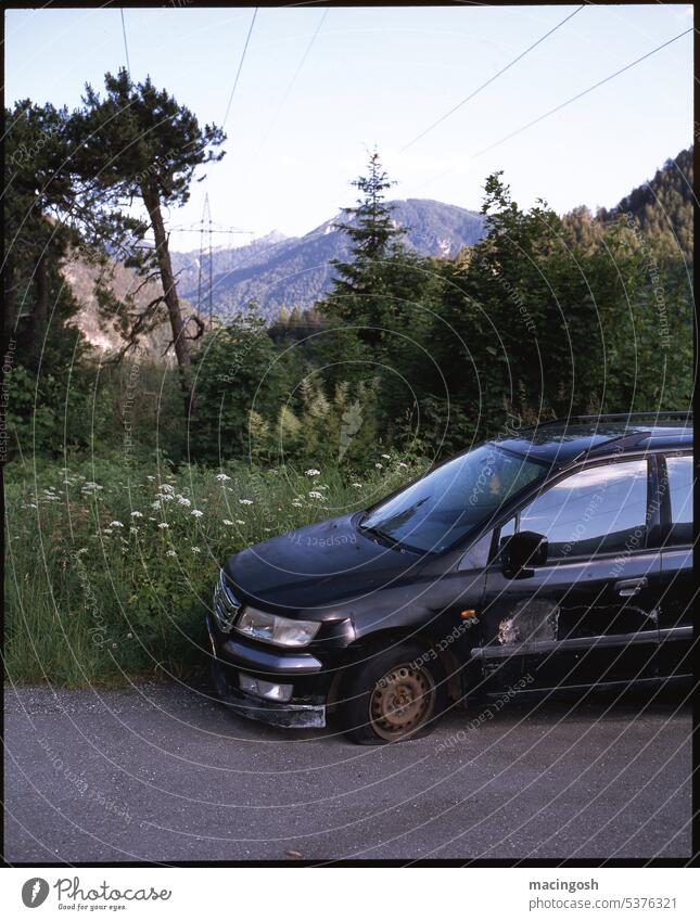 Car wreck in front of mountain scenery Deserted nobody Exterior shot Twilight Vehicle car Motor vehicle Wrecked car Scrap metal Environmental pollution Disposal