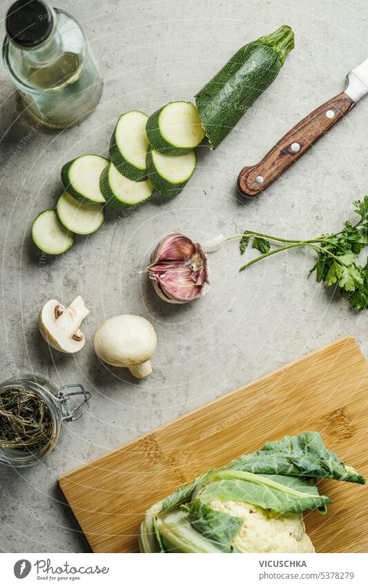 Sliced zucchini and other vegetables ingredients on kitchen desk, top view. Healthy cooking and eating concept sliced healthy cooking above diet background raw