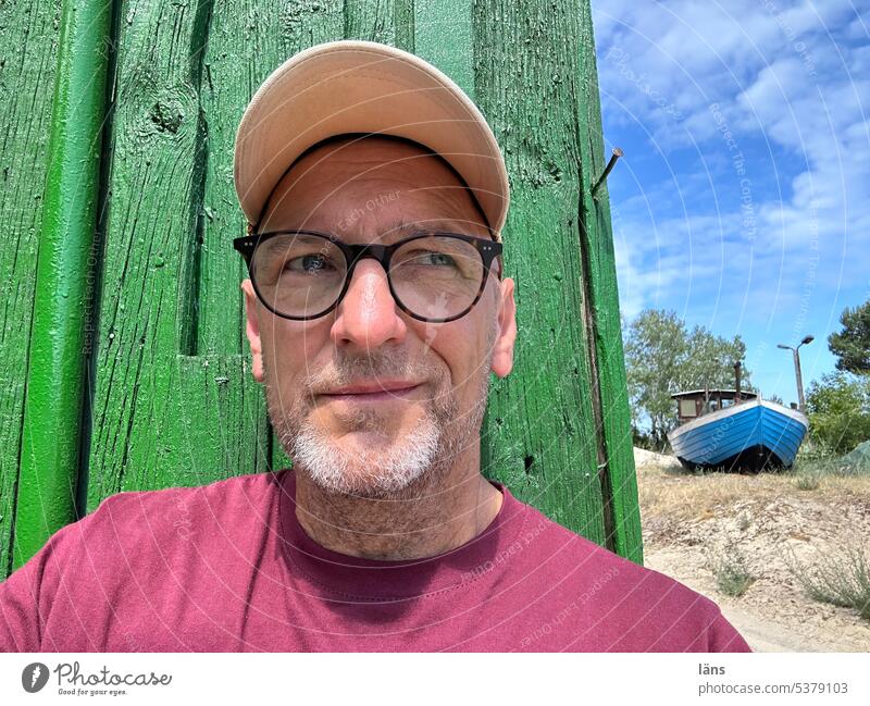 My house, my boat, hmm Man Only one man portrait 1 Person Face of a man House (Residential Structure) Fishing boat Fishermans hut Senior citizen