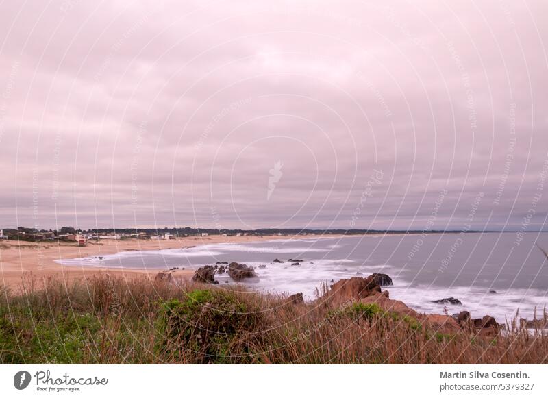 Sunset at Playa del Desplayado in the tourist city of La Pedrera in Uruguay. america ancient architecture atlantic background beach buildings coast coastline