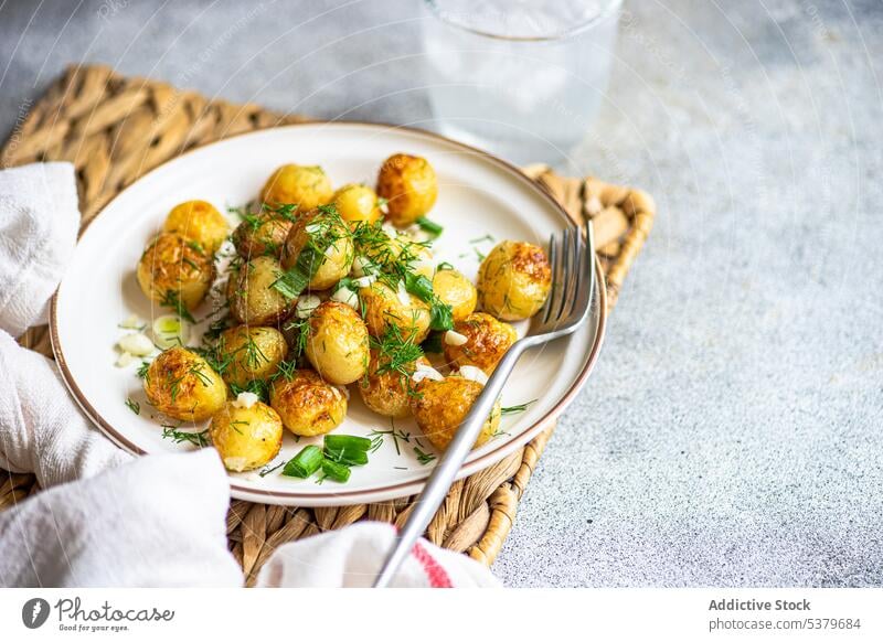 Fried spring potato vegetables baked bowl crusty fork fresh fried green healthy herb kitchen light nutrition organic salad served spice stone tasty vegan plate