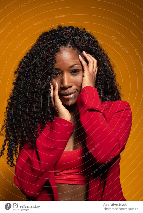 Sensual woman with curly hair in red clothes model style suit trendy outfit sensual fashion color female positive black young african american appearance