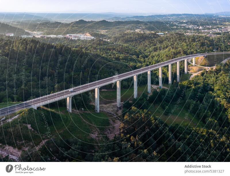 Picturesque drone view of long road bridge infrastructure transport valley forest highway hill landscape route roadway nature tree freeway asphalt construction