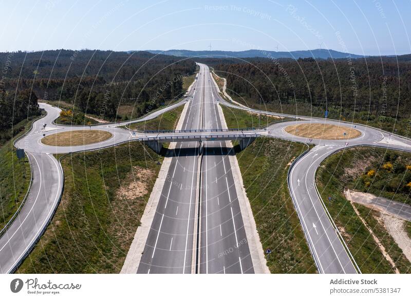 Drone view of roads with exit points from main highway intersection junction crossroad regulation asphalt traffic route transport vehicle field roadway