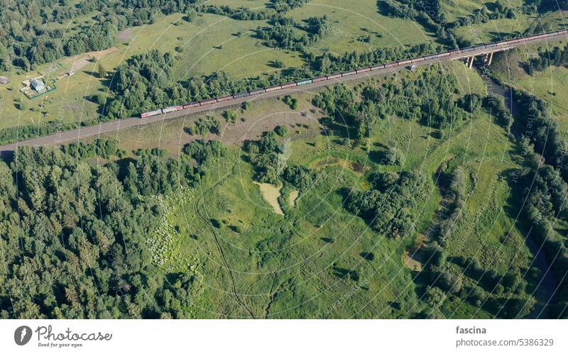 aerial view of freight train carriages with coal high railway line bridge drone filled fuel river transport transportation construction landscape road track air