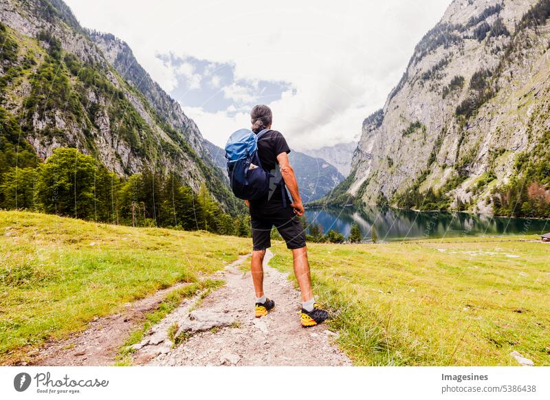 Backpacker. Man hikes. beautiful Bavarian landscape behind and between Königsee and Obersee, Schönau am Königssee. backpacker Hiking beautifully Landscape