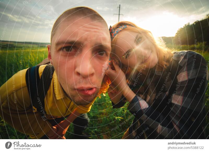 Playful happy handsome couple having while walking in woods. tourists in the mountains. Adventure in nature concept. lifestyle love playful piggyback outdoors