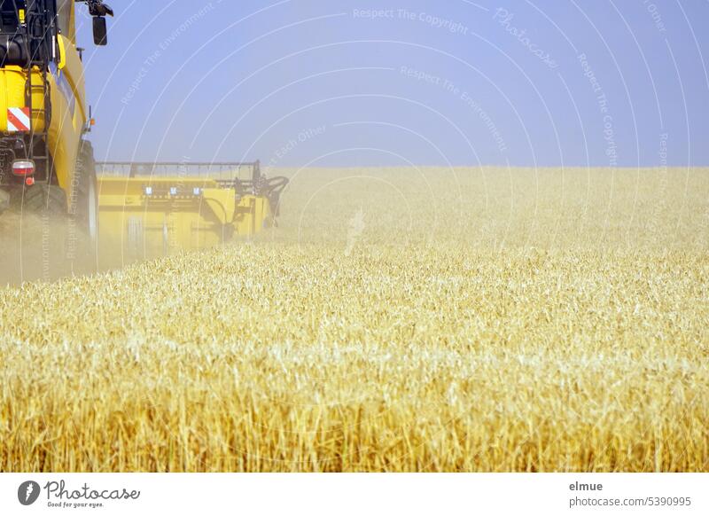 Combine harvester harvesting grain Grain harvest Barleyfield Agriculture harvest season Harvest Blog spike July Summer Grain field Agricultural crop Cornfield