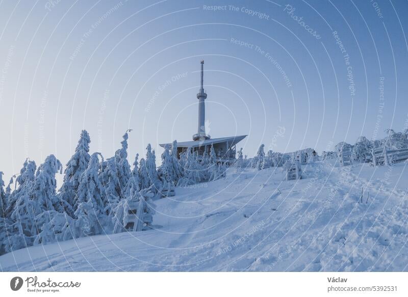 Frosty start of the day at the radio transmitter on Lysa Hora, the highest mountain in the Beskydy Mountains. Ice crust on the weather station building. Waking up to life