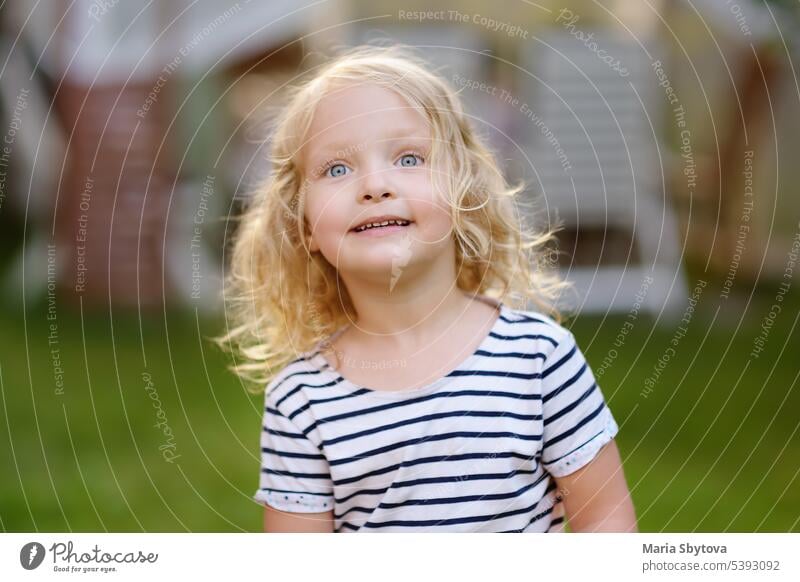 Cute toddler girl outdoors portrait in summer day. Smiling and charming child. baby behavior blond blonde blue calm caucasian character childhood compliant