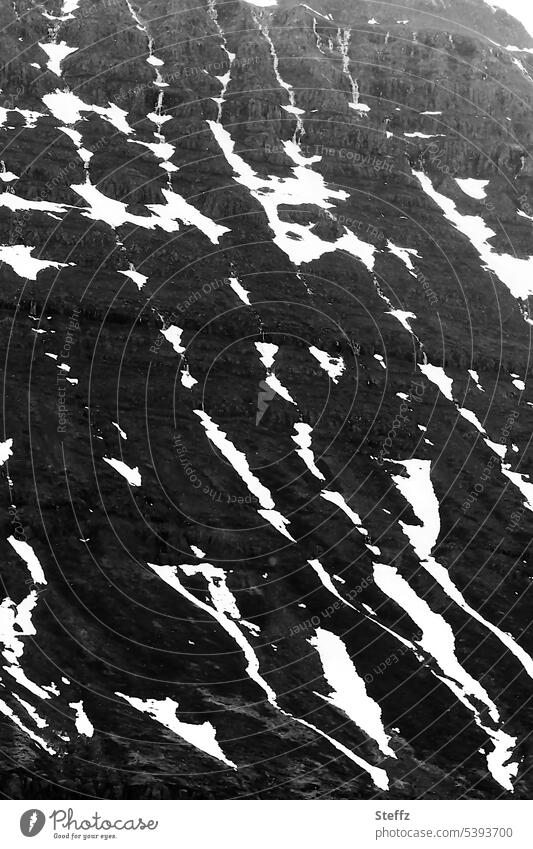 Remnants of snow on a hill in Iceland East Iceland Icelandic Seydisfjördur Wall of rock Snow Hill Rock mound Steep Steep face Snow melt rock formation Nordic