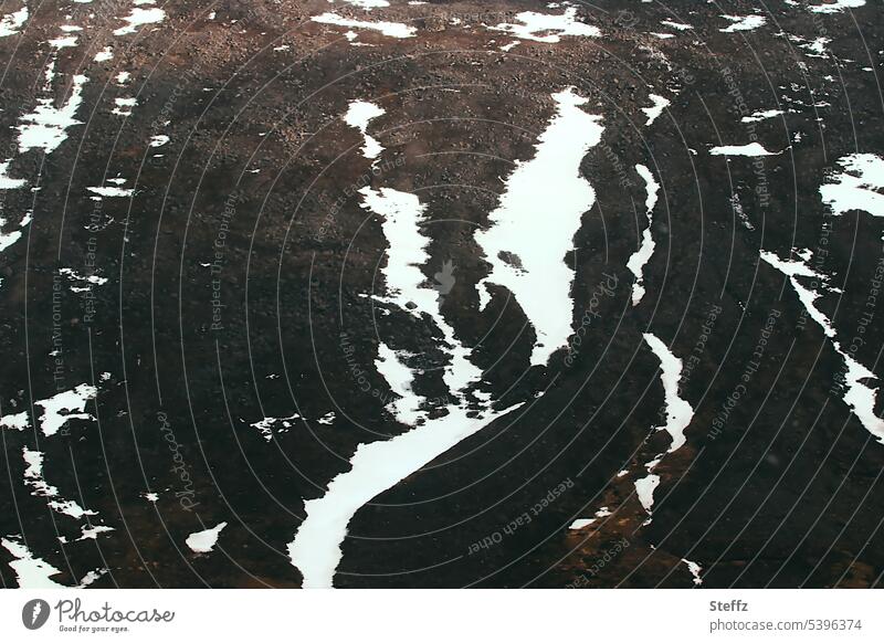 Mountain side with snow remains on Iceland East Iceland shape Snow forms cryptic mystery natural forms Mysterious Figures Dark Mystic fantasy world