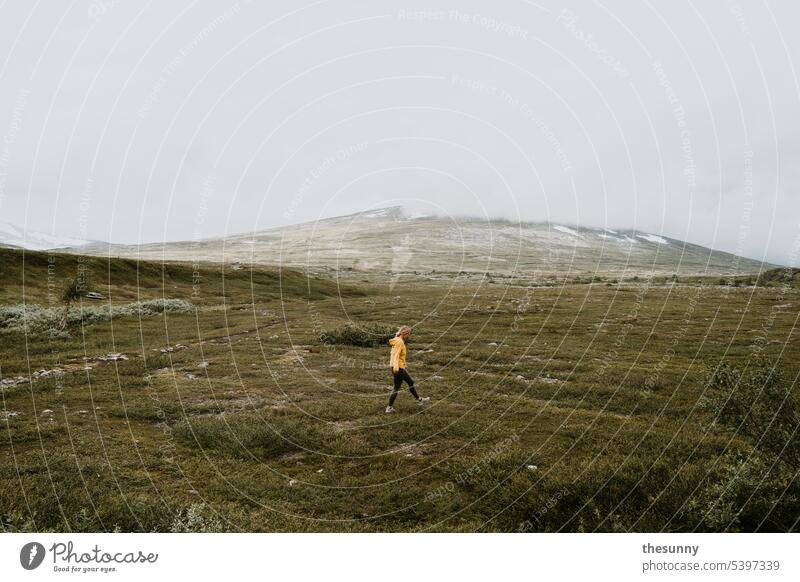 Woman running through a mossy landscape Norway Vacation in Norway yellow jacket stroll man and nature Moss Carpet of moss moss landscape moss-covered Mountain