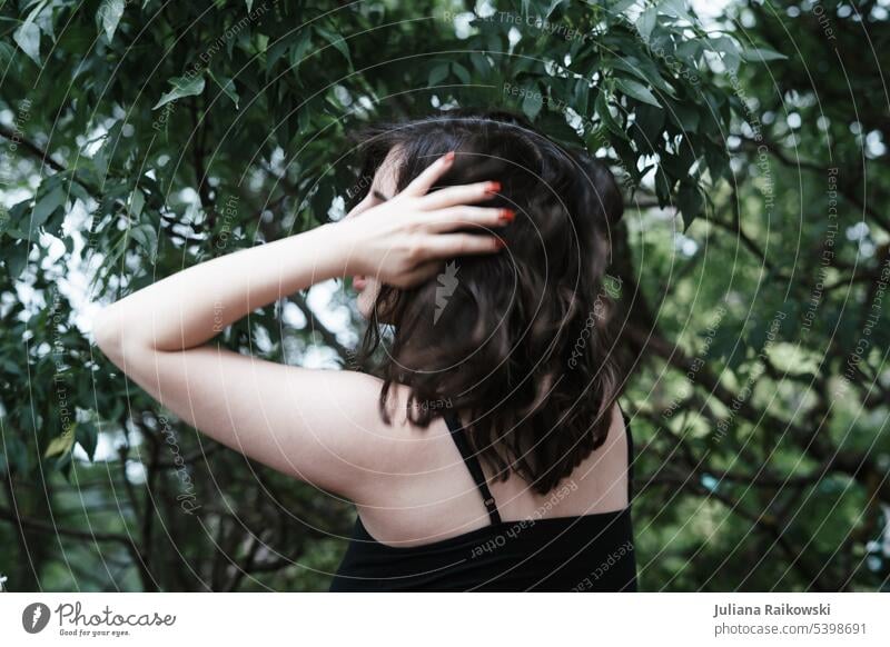 Woman grabbed her hair in nature 18 - 30 years Elegant Beauty Photography Strand of hair melancholy Style Back Arm Authentic Head Rear view Long-haired pretty