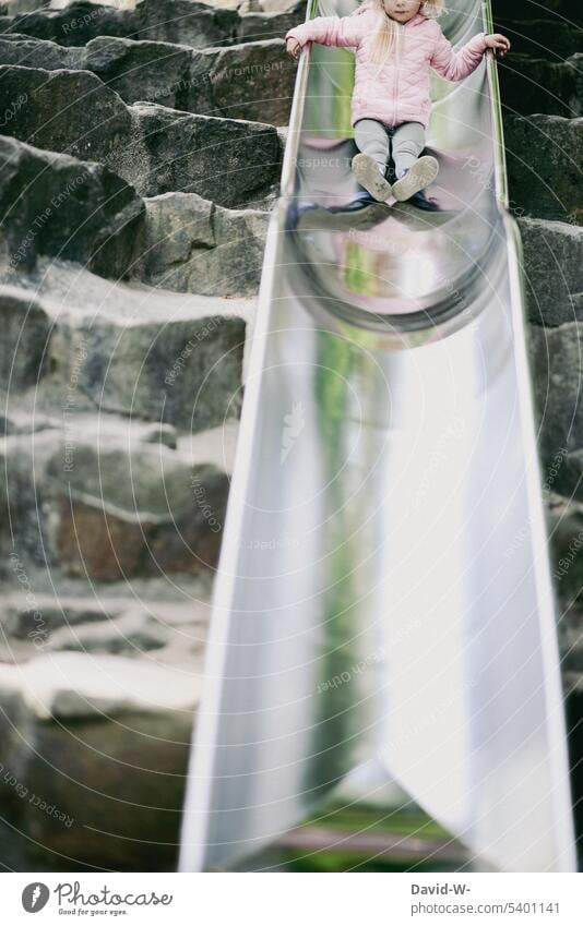 Child sliding down the slide on a playground Slide Skid Playground fun courageous Playing Infancy Movement overcoming Girl Brave reflection swift