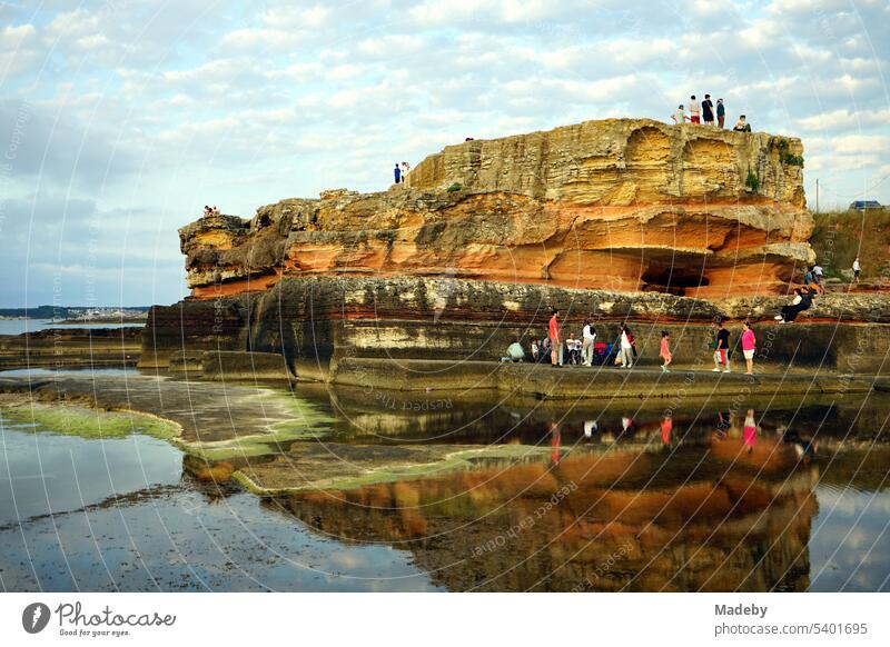 Red shimmering rugged rock on the Black Sea coast in summer sunshine at the Pink Rocks in Kefken in Kandıra province of Kocaeli in Turkey Mood lighting