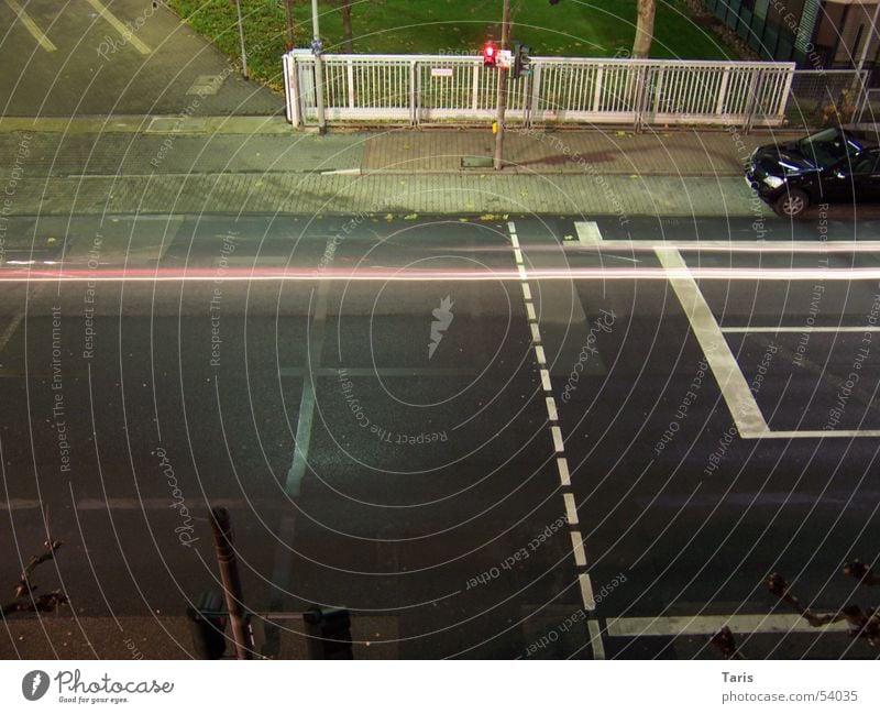 Drive on the line Night Traffic light Red Lighting Sidewalk Speed Fence White Stripe Long exposure Leadfoot Car race Dangerous Exterior shot Bird's-eye view