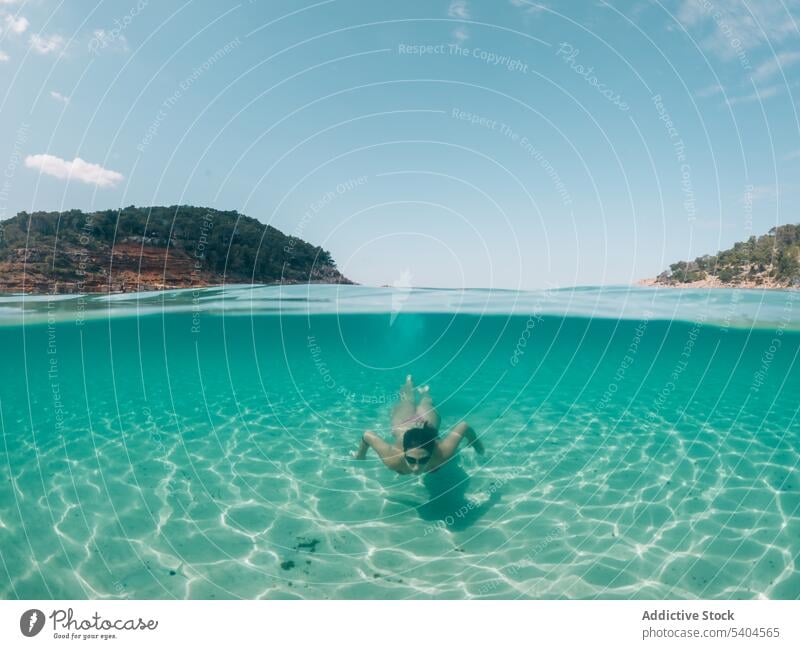 Woman swimming in blue sea woman dive goggles bikini turquoise ocean summer weekend female balearic islands swimwear swimsuit sunbath travel seascape coast