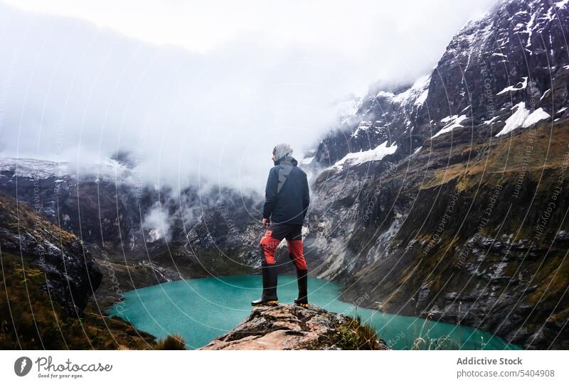 Man traveler admiring cloudy mountain and river admire lake volcano nature cliff landscape tourist altar ecuador female adventure vacation rock highland