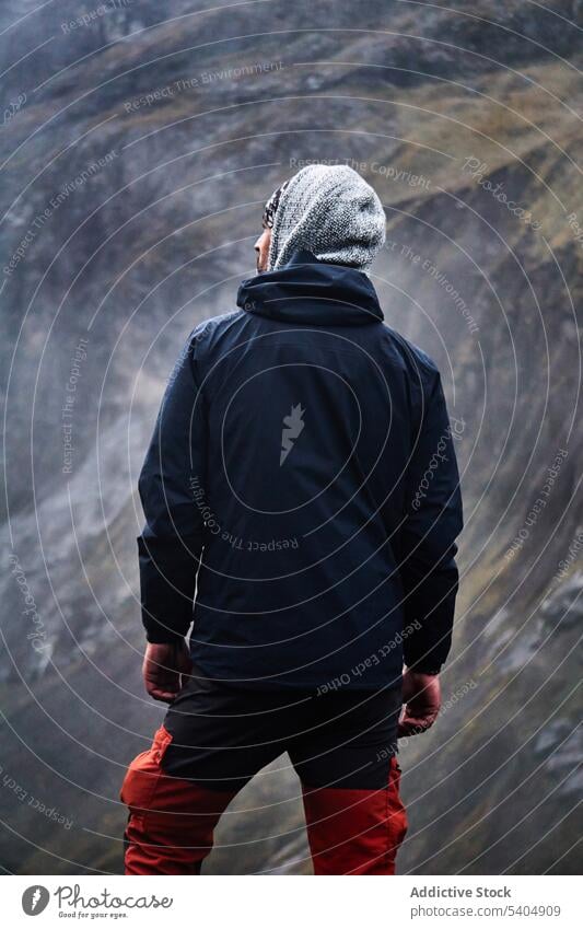 Young male hiker standing on cliff man mountain admire volcano altar traveler nature rocky valley ecuador adventure picturesque scenic highland wanderlust