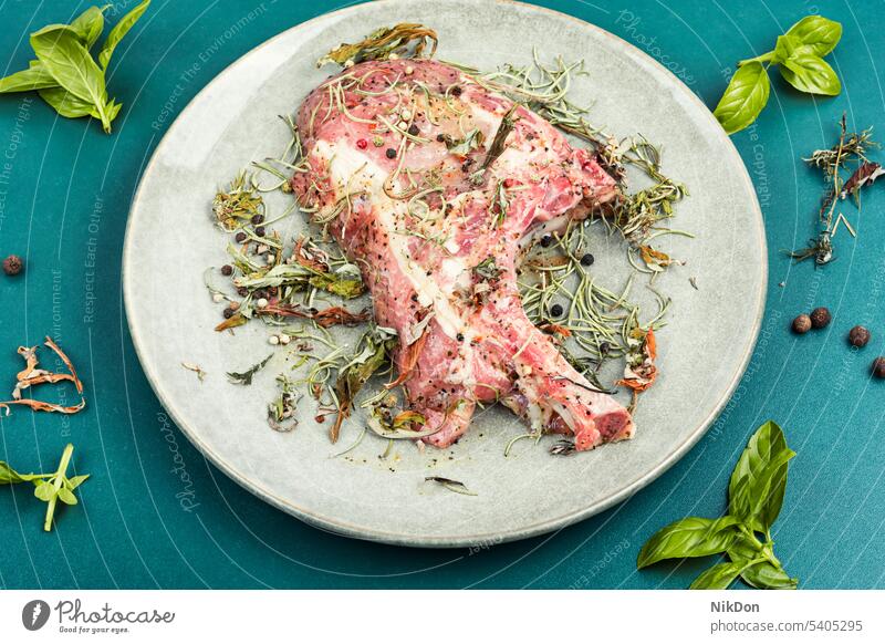 Raw barbecue Tomahawk steak meat raw pork herb tomahawk uncooked seasoning bone rib cut tomahawk steak fresh food butcher rosemary pepper spice chop preparation