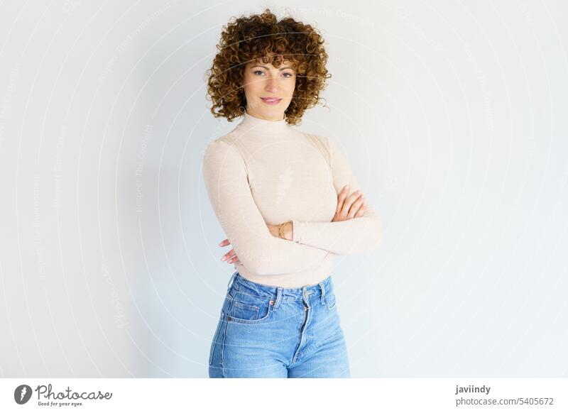 Confident woman with crossed arms against white background confident arms crossed self confident hands crossed studio arms folded studio shot posture portrait