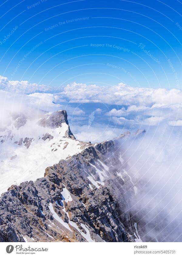 View from the Zugspitze near Garmisch-Partenkirchen in Bavaria Alps mountain Wetterstein Peak Wettersteingebirge Landscape Nature Summer Sky Clouds Blue